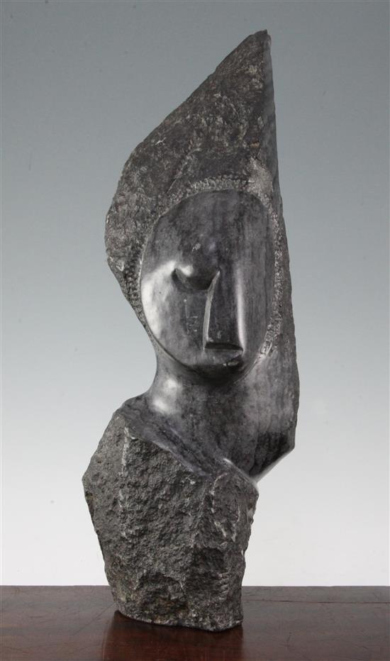 A Shona black serpentine carving of a head, possibly by John Takawira (1938-1989), 18.75in.